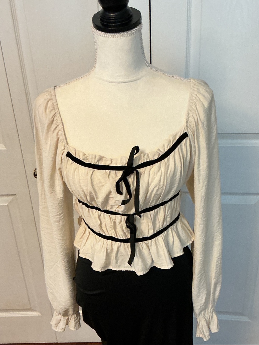 Women's Cream Ruffle Peplum Long-Sleeve Top with Black Trim